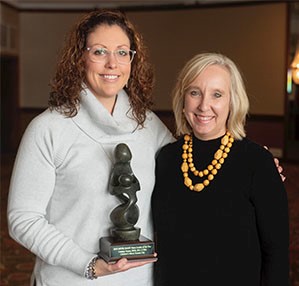 Lindsay Jessee, left, receives her award from Tena Barnes Carraher, Co-Founder, Vice President Regional Program Director, The DAISY Foundation.